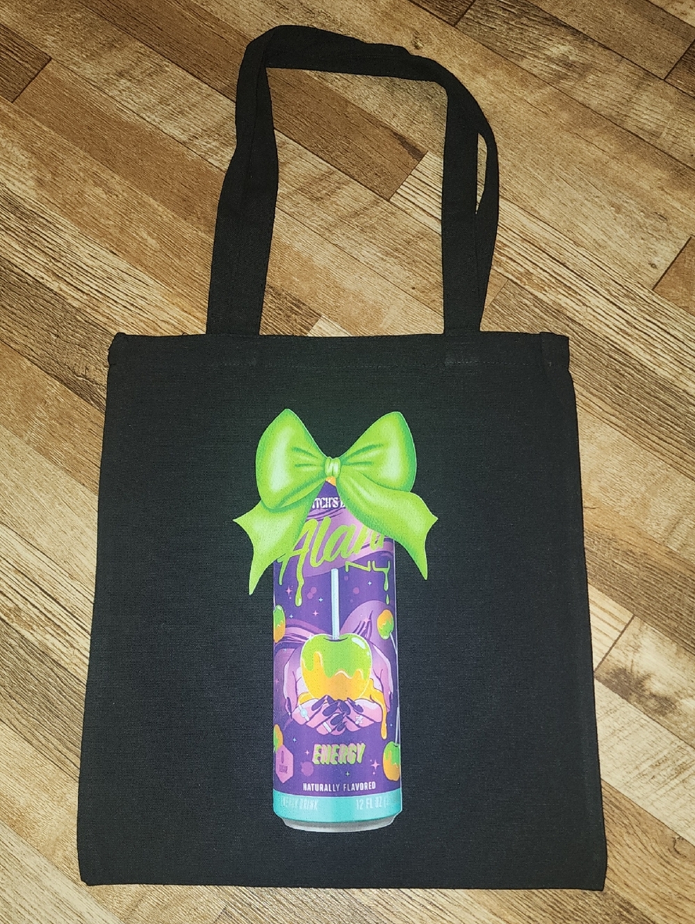 Black Tote Bag with Purple & Green Alani Witches Brew Graphic. 13x15